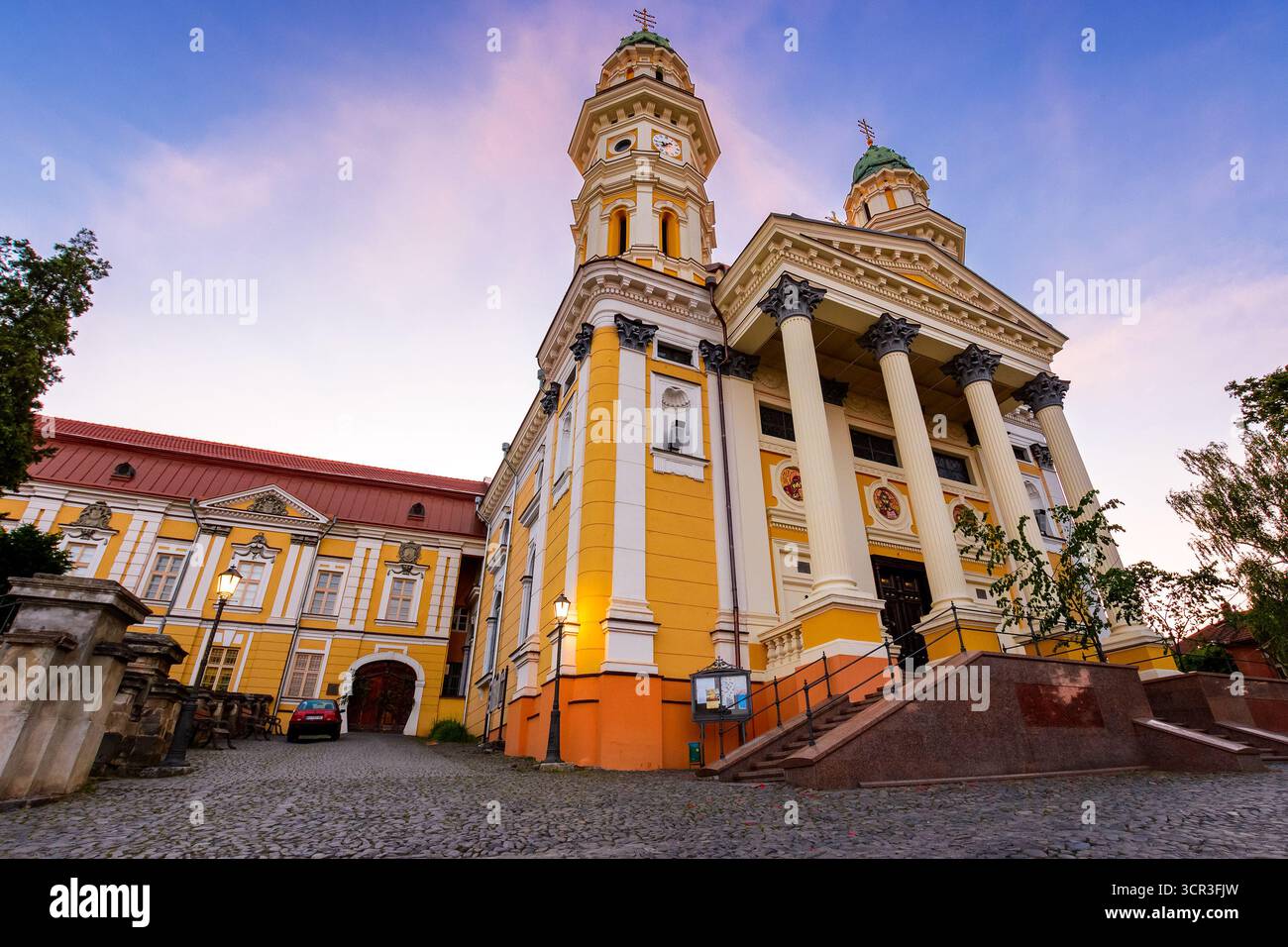 uzhhorod, ukraine - 04 jun 2017: holy cross cathedral at sunrise in summer. beautiful view of greek catholic church in center of old town. dome and co Stock Photo