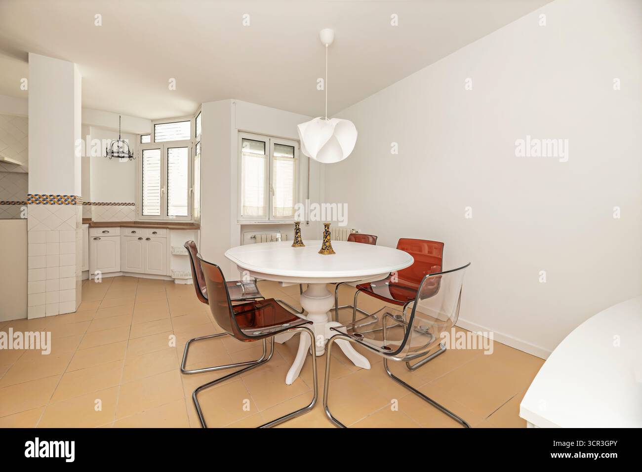 Elegant dining room with an oval   table and blue velvet chairs, ideal for formal dinners with guests Stock Photo