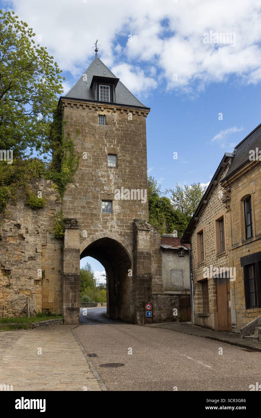 View of the lovely old Fortifications of Mouzon, in the Ardennes department in northern France. An original medieval gatehouse and wall at the entranc - Stock Image