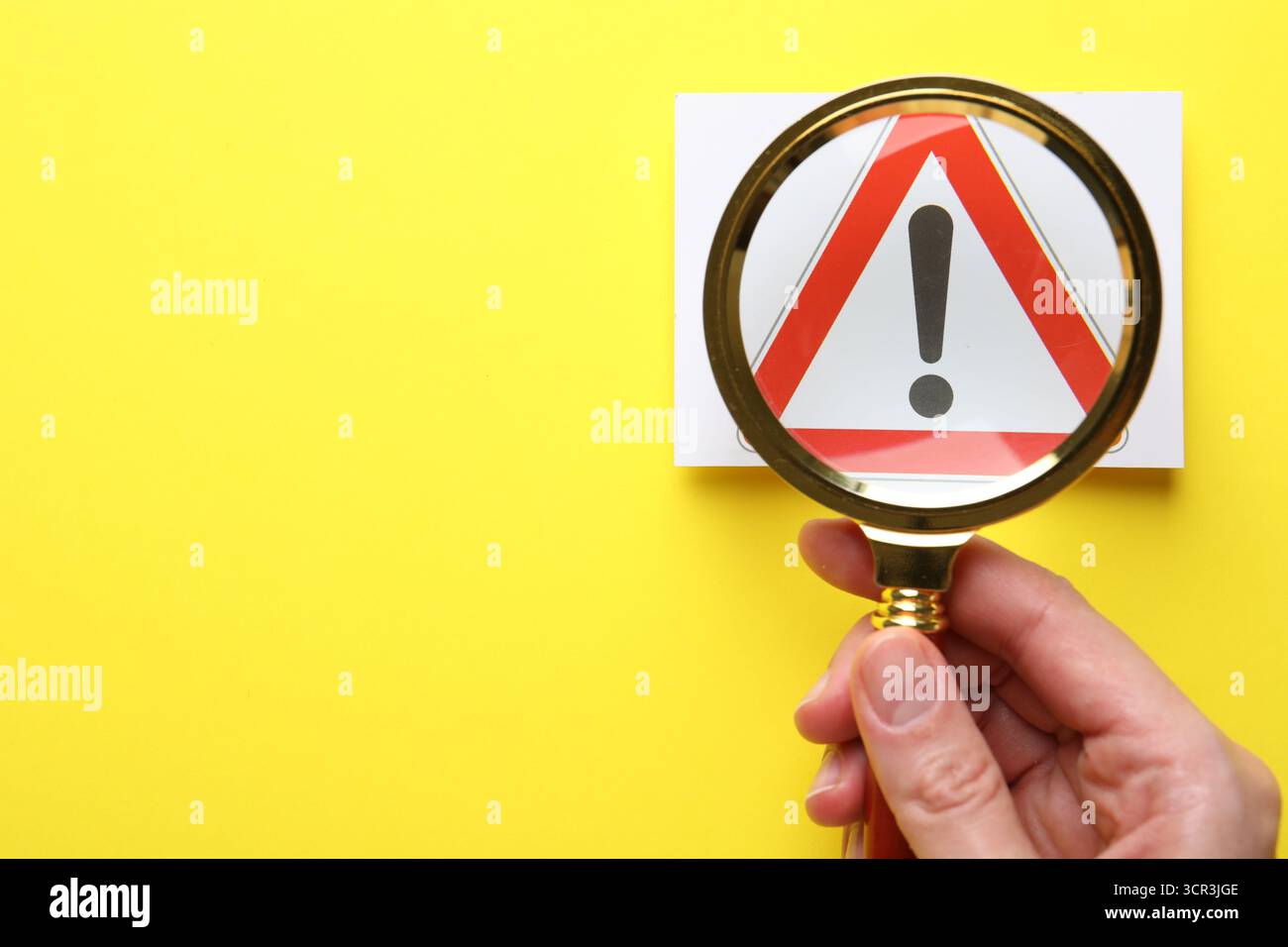 Risk. Woman with magnifying glass and warning sign on yellow background ...