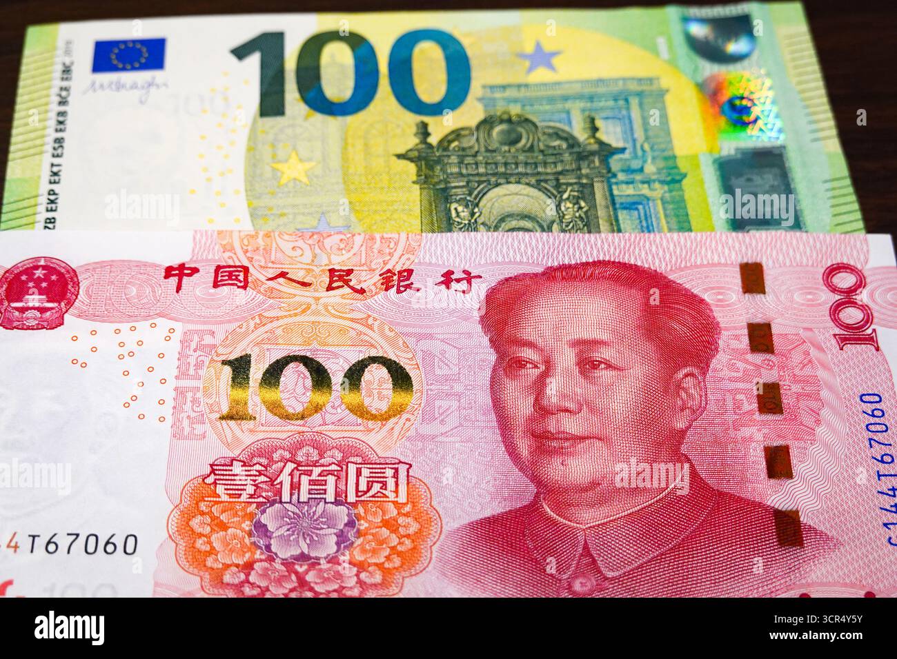 China. 29th Sep, 2025. A 100 yuan note seen displayed on a 100 euro note.  Credit: SOPA Images Limited/Alamy Live News Stock Photo - Alamy