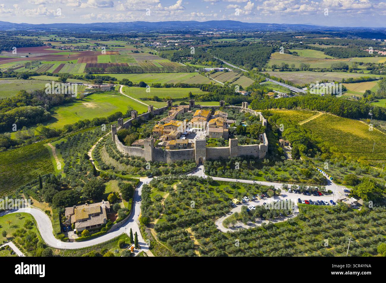Aerial view of the fortified medieval village with a stone wall and ...