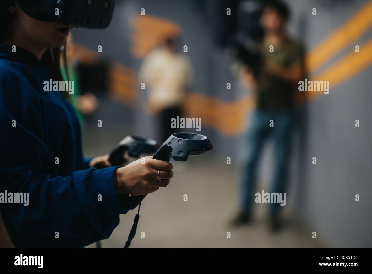 Person Immersed in Virtual Reality Experience Using Advanced Controllers Stock Photo
