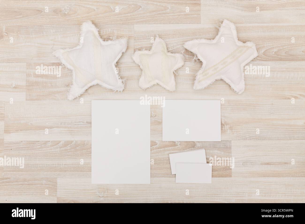 Creative workspace featuring fabric stars and blank papers for craft projects Stock Photo