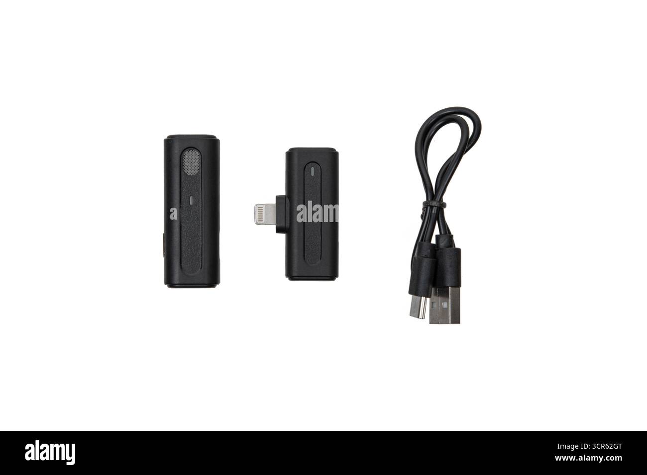 Wireless microphone transmitter, receiver, and charging cable isolated on white background. Stock Photo