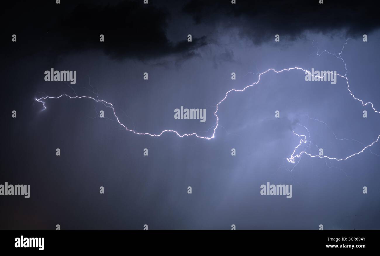 Bright lightning bolt illuminating the sky Stock Photo - Alamy