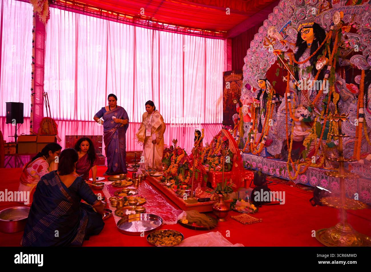 India. 04th Mar, 2034. GURUGRAM, INDIA - SEPTEMBER 29: A Hindu priest performs Maha Saptami Bhog Aarti to Goddess Durga during the Durga Puja festival at the Community Centre in Sector-46, organised by Sahashrabdi Durga Puja Samity near Huda Market on September 29, 2025 in Gurugram, India. (Photo by Parveen Kumar/Hindustan Times/Sipa USA) Credit: Sipa USA/Alamy Live News Stock Photo