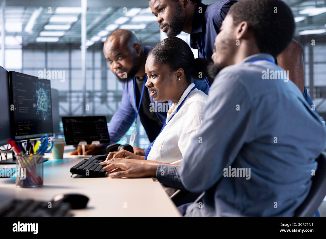 Developer works together with colleagues in server farm, using artificial intelligence tech for increased productivity. Teamworking data center employees collaborating to implement AI driven solutions Stock Photo