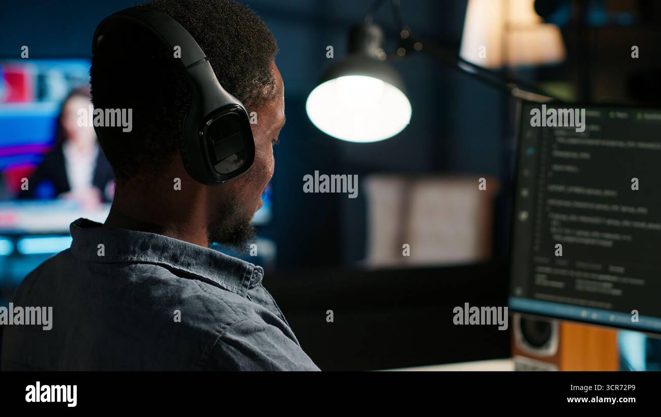 Male developer entering binary data on terminal panel while writing html code. Software engineer working on troubleshooting with programming language, internet and server security. Camera B. Stock Photo