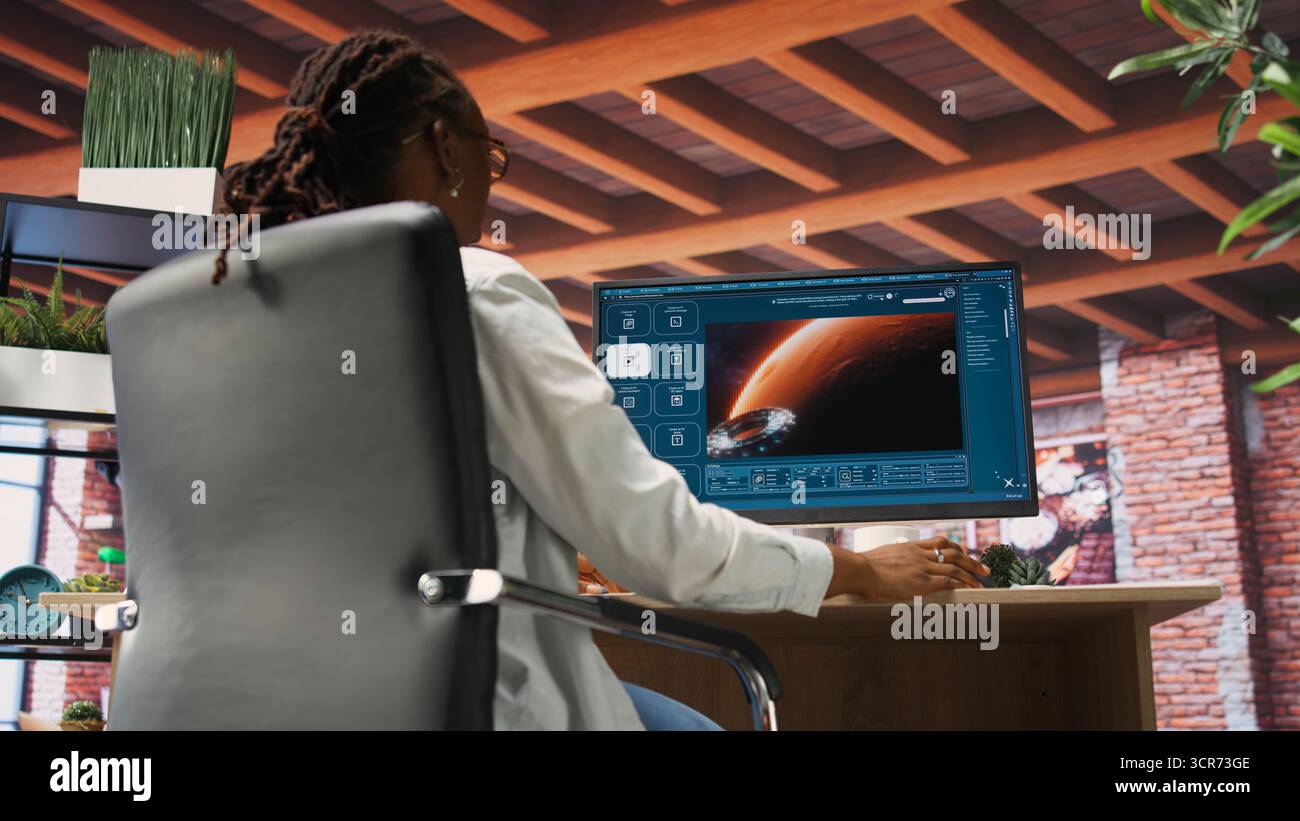 Woman at home using generative artificial intelligence website generating videos using diffusion models. Person drinking coffee and using AI virtual assistant producing clips, camera B Stock Photo