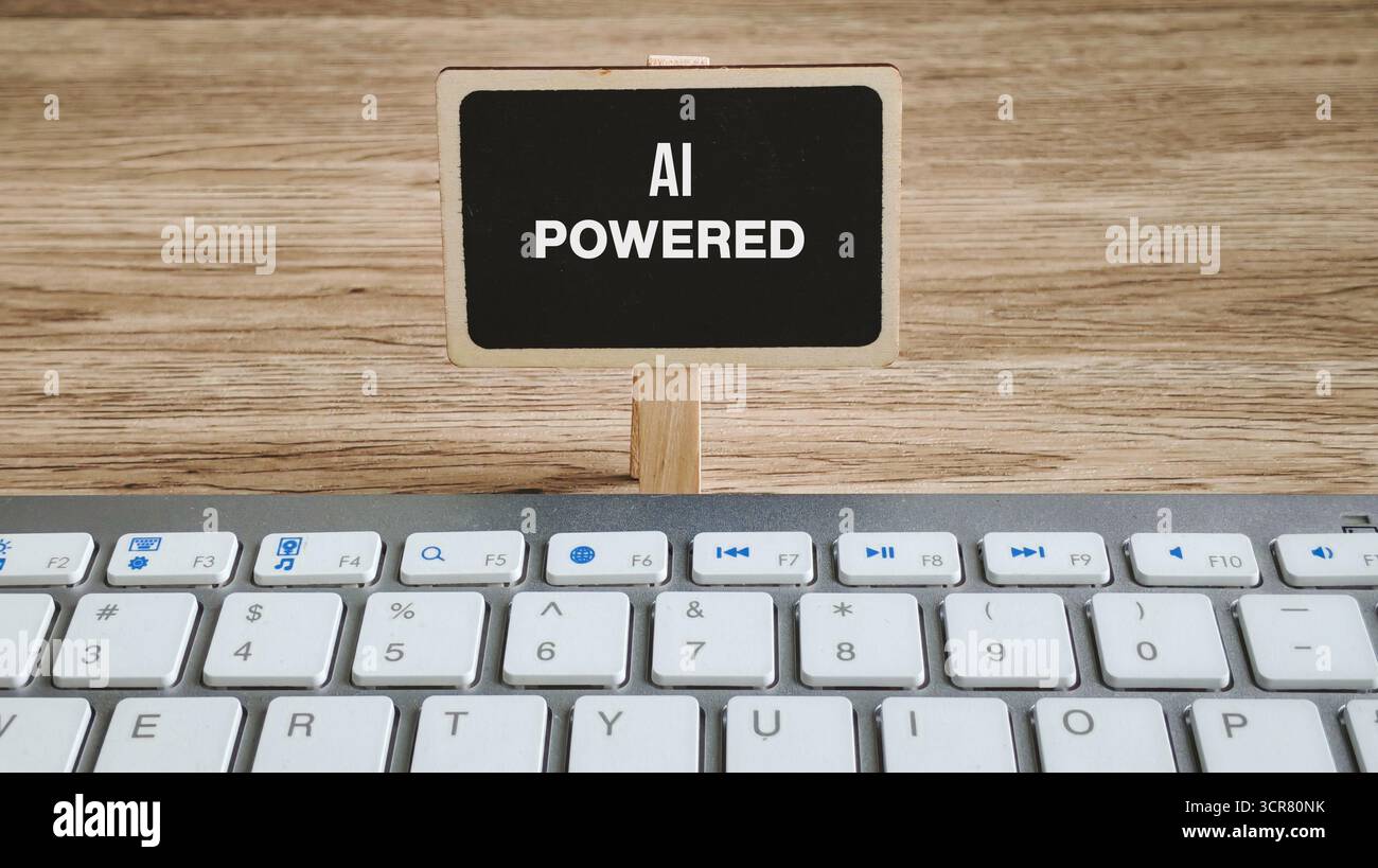 AI Powered Concept on Mini Chalkboard Above a Computer Keyboard Representing Artificial Intelligence Technology Stock Photo