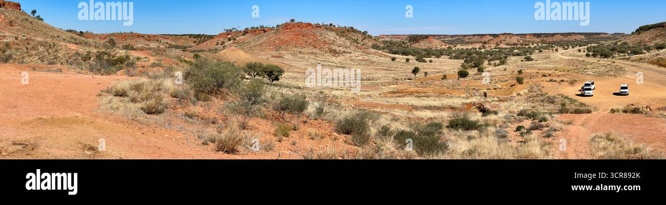 Campervans travelling through remote outback Queensland Australia, bush landscape. Road trip between Mount Isa and Winton. - Smartphone Captured Stock Image