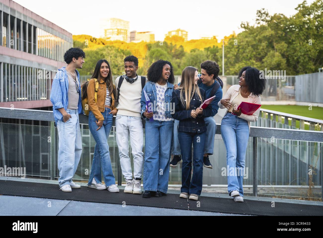 Group of young multicultural students standing together, chatting, and ...