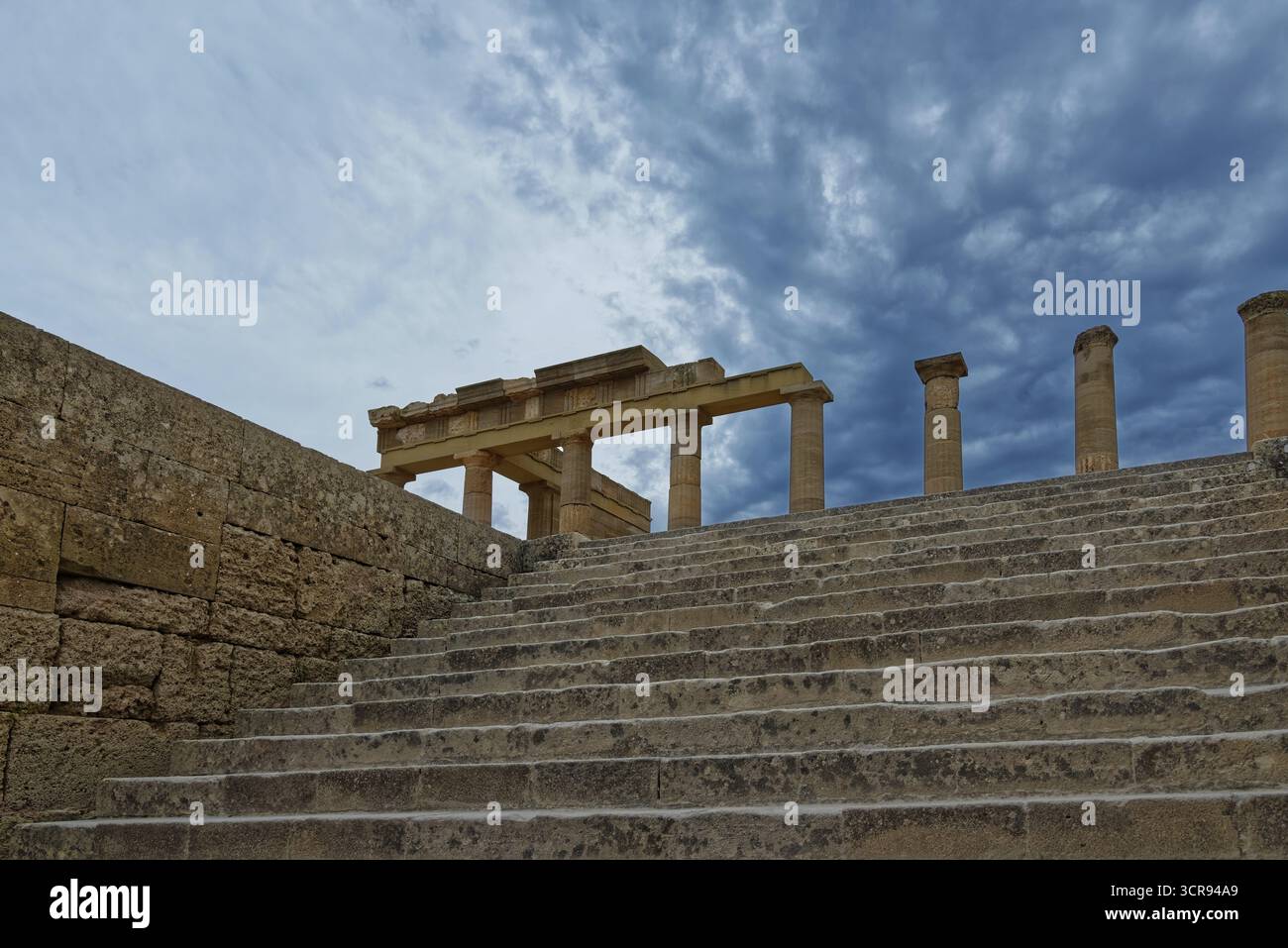 Ancient ruins with stone steps and columns of the Acropolis of Lindos ...
