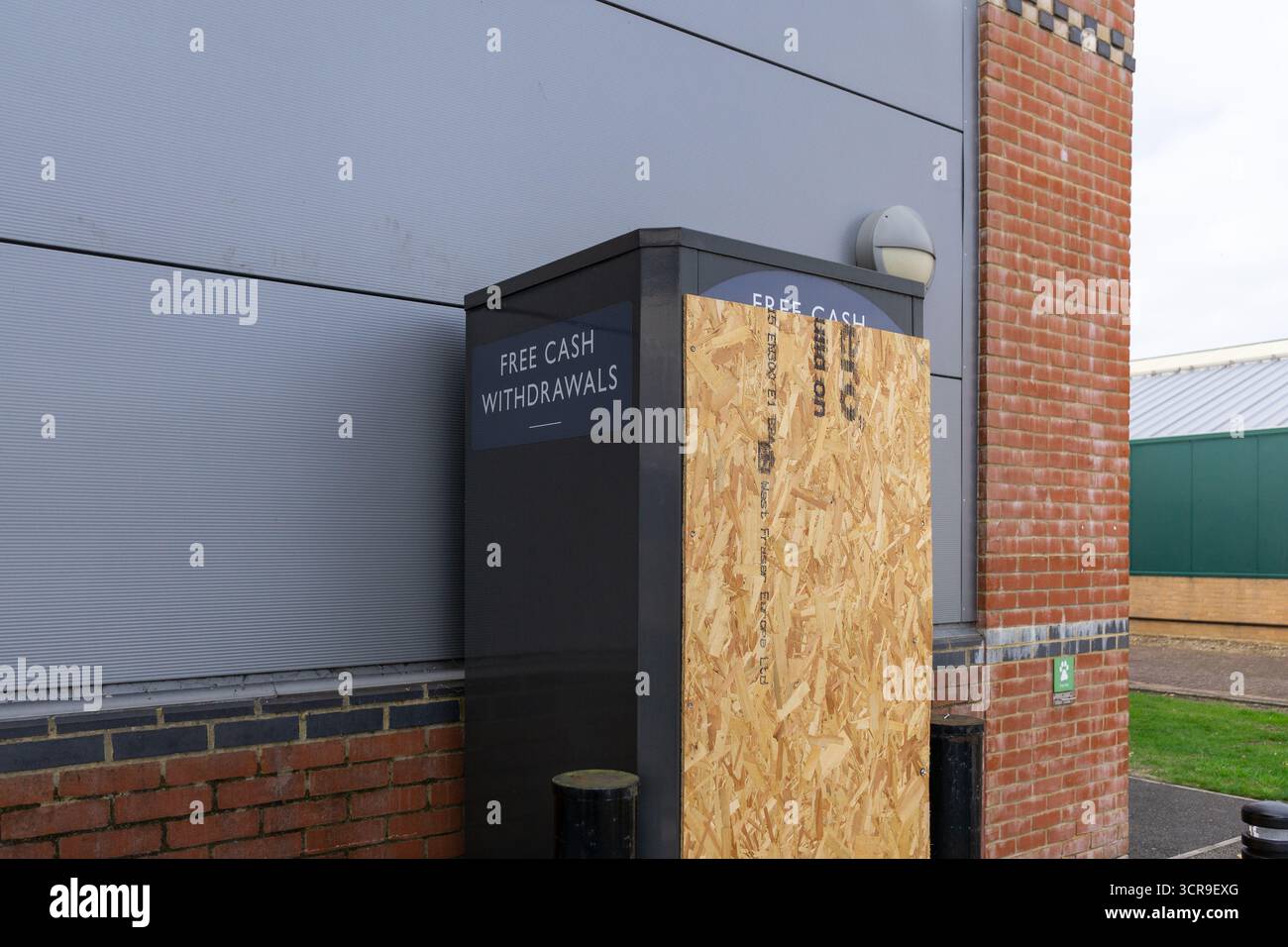 A boarded up external ATM following a raid outside Waitrose Supermarket, Wootton, Northampton, UK Stock Photo