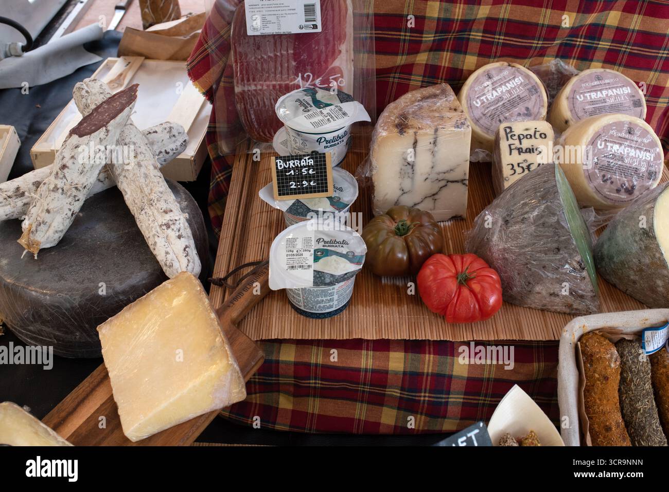 Display of Saucissons and Italian Cheeses, inclding Burrata, Pepato and Utrapanisi, on Market Stall in Aix-en-Provence Provence France Stock Photo