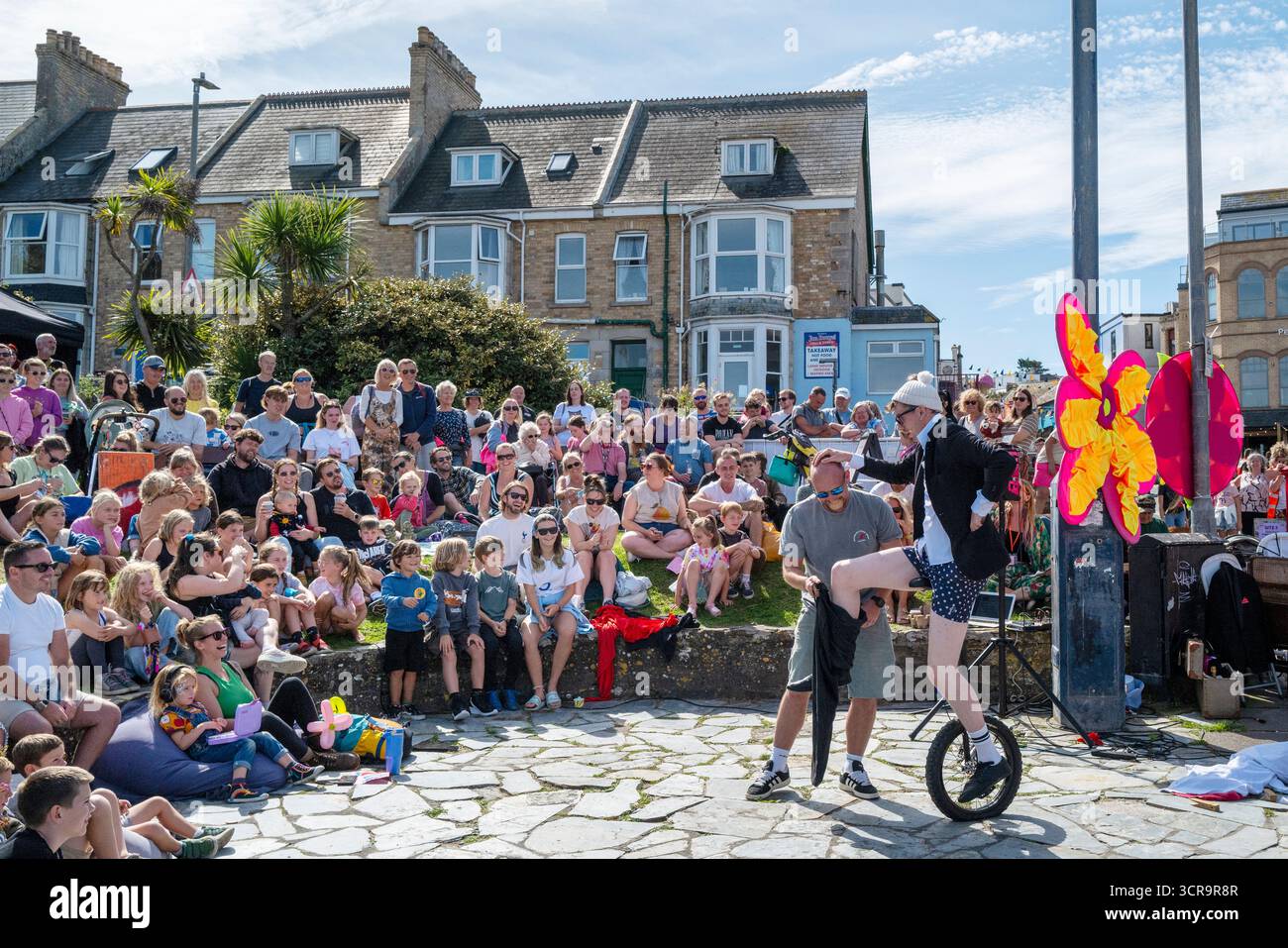 Sam Goodburn performing his show Wire Attire in Beachfield gardens in Newquay in Cornwall in England in the UK. Stock Photo
