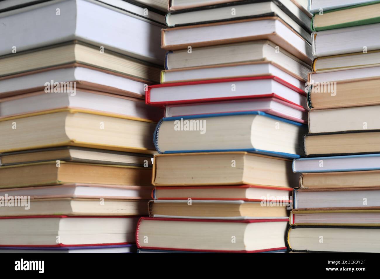 Many different stacked books as background, closeup Stock Photo