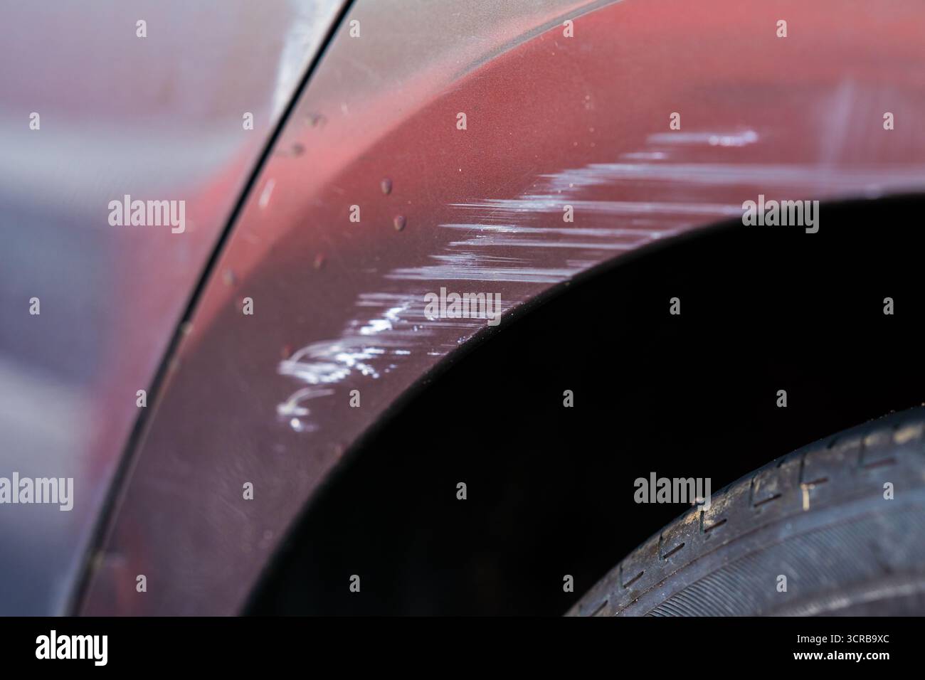 Scuff marks on the wheel arch of a grey hire car Stock Photo