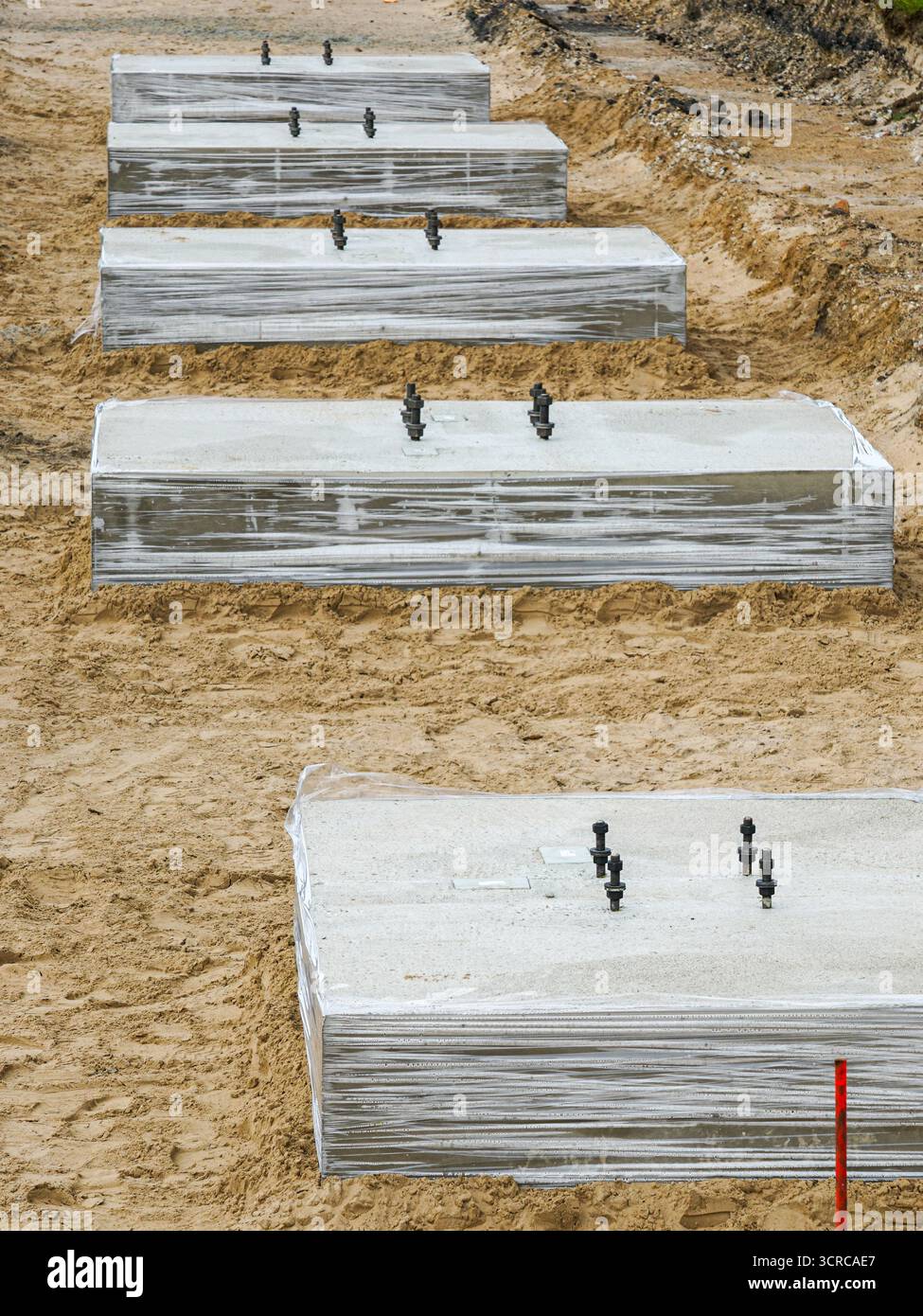Concrete foundation blocks installed in sandy ground at construction ...