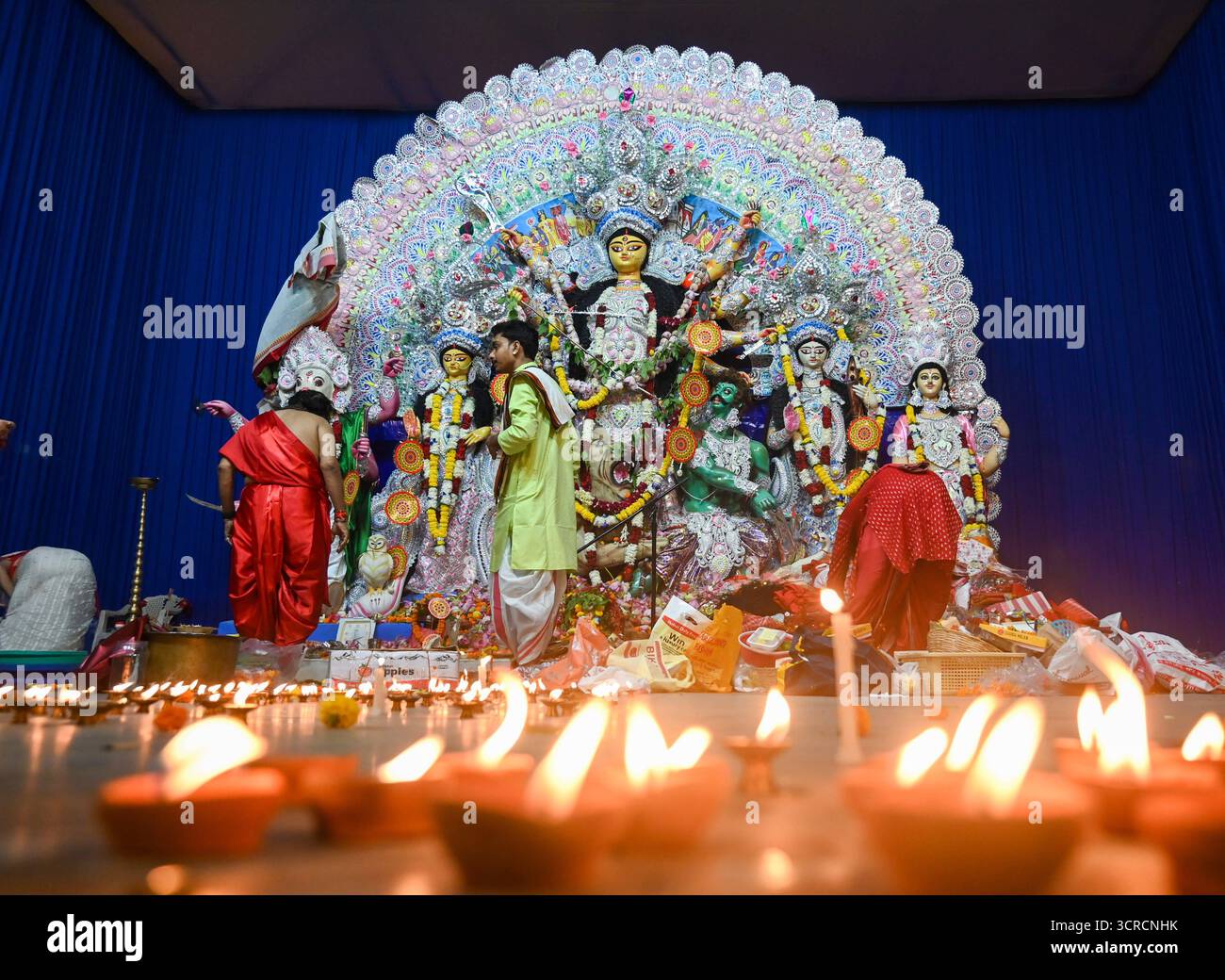 NOIDA, INDIA - SEPTEMBER 30: Devotees light earthen lamps Diyas while ...