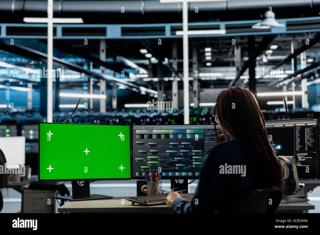 Engineer in data center using green screen computer to check equipment performance upgrading infrastructure. Worker doing maintenance on supercomputers in servers room using mockup PC Stock Photo