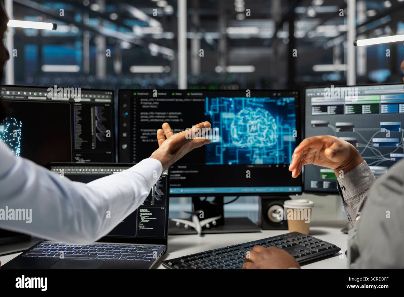 Data center technicians brainstorming, working together in office, using artificial intelligence computerized model. Server room coworkers collaborating, working with AI machine learning algorithms Stock Photo