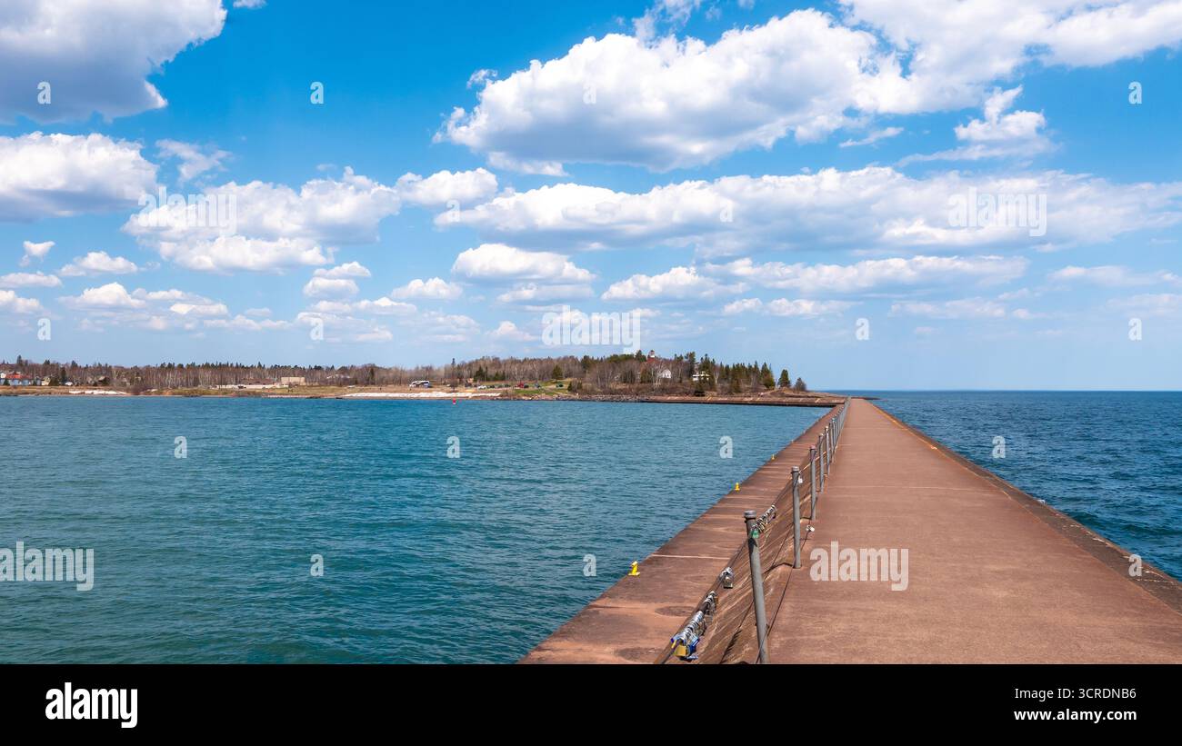 The blue waters of Lake Superior and Agate Bay are seen from the jetty in Two Harbors, Minnesota on a beautiful spring day in Minnesota. Stock Photo