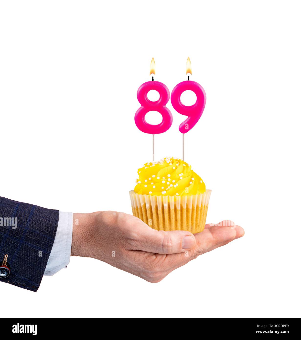 Hand handing a cupcake with a number 89 candle - Birthday on a white background Stock Photo