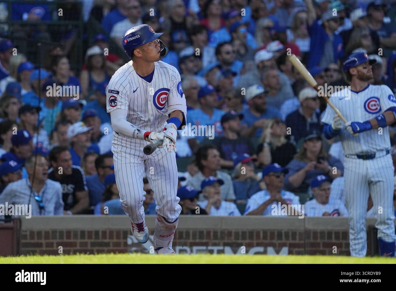 Chicago Cubs' Seiya Suzuki, of Japan, watches after hitting a home run ...
