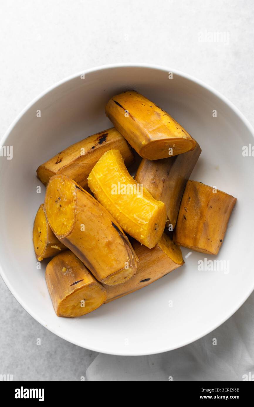 overhead view of Boiled ripe plantain in a white bowl, top view of ...