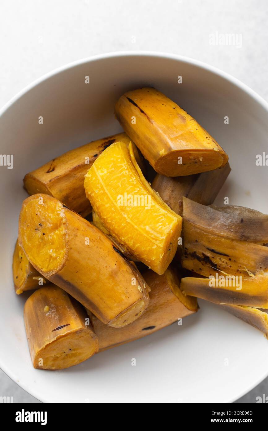 overhead view of Boiled ripe plantain in a white bowl, top view of ...