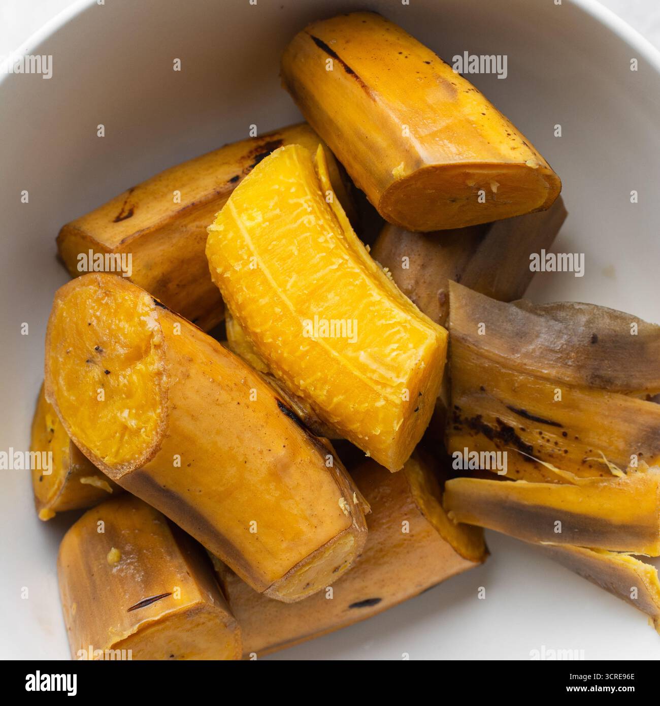 Plaintain Rope overhead view of Boiled ripe plantain in a white bowl, top view of ...