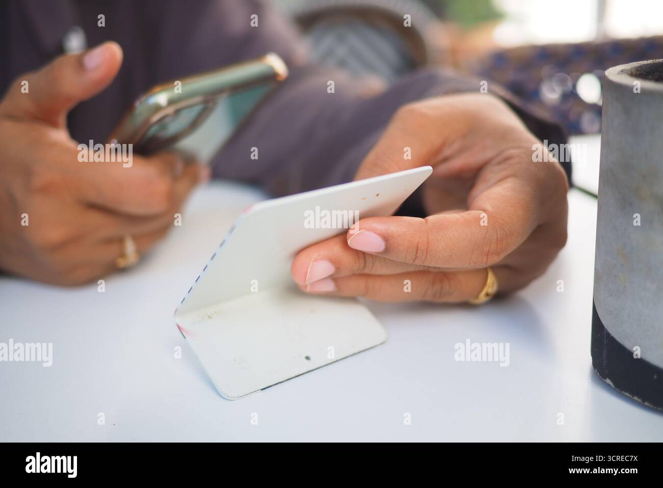 woman using smart phone to scan the cafe QR code to find the menu Stock Photo