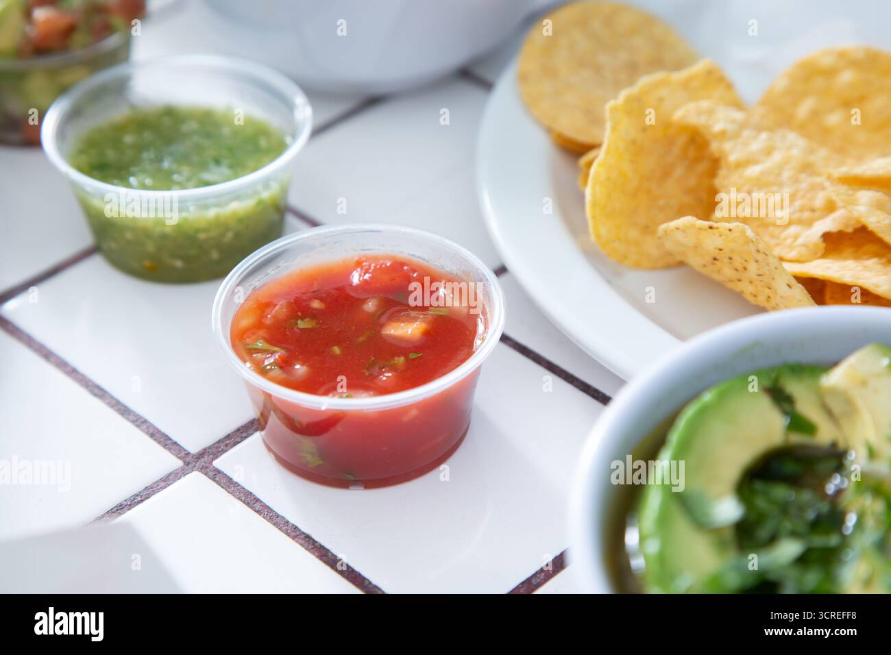 A view of a condiment cup of red salsa. Stock Photo
