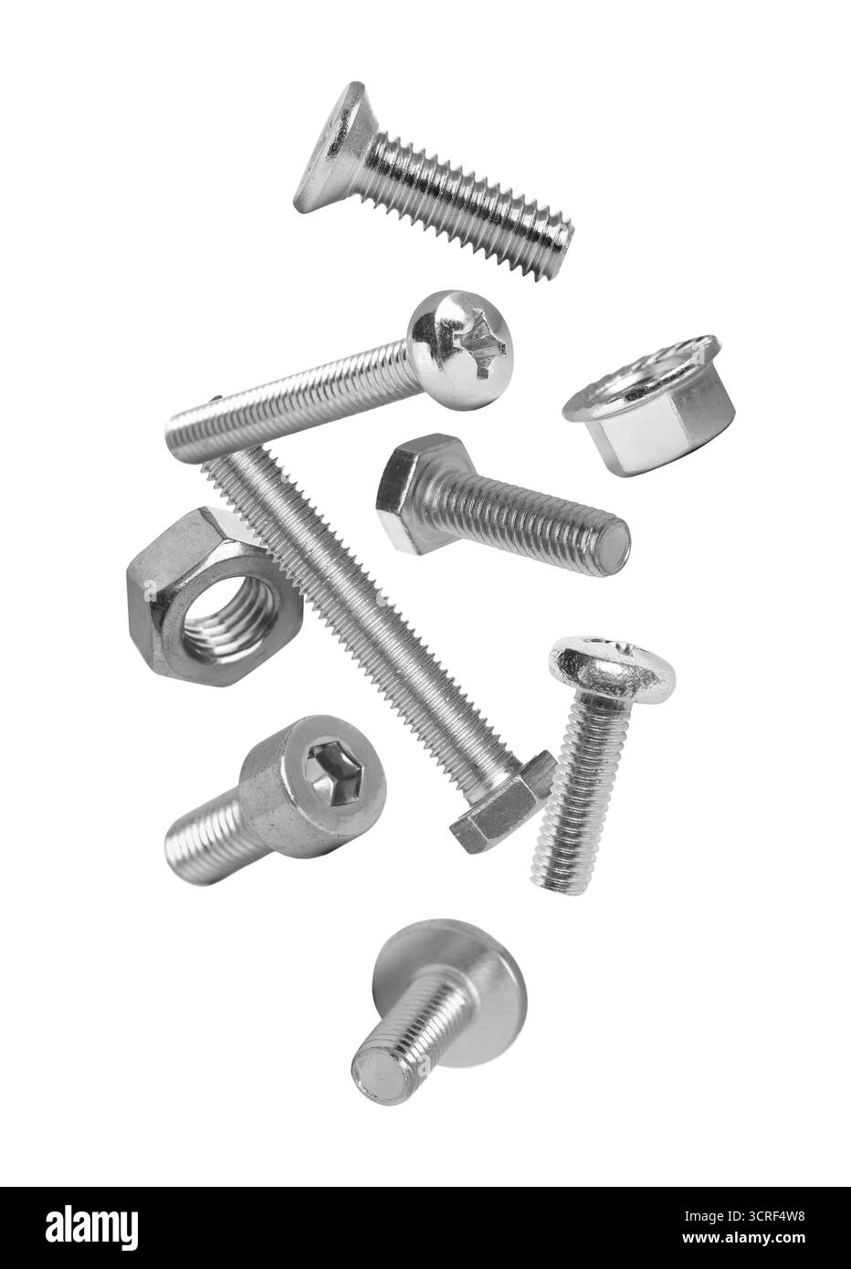 Different bolts and nuts falling against white background Stock Photo