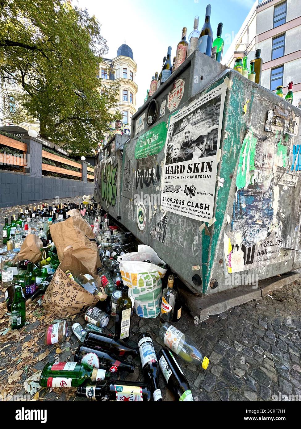 Overflowing glass collection containers in Berlin - Smartphone Captured Stock Image
