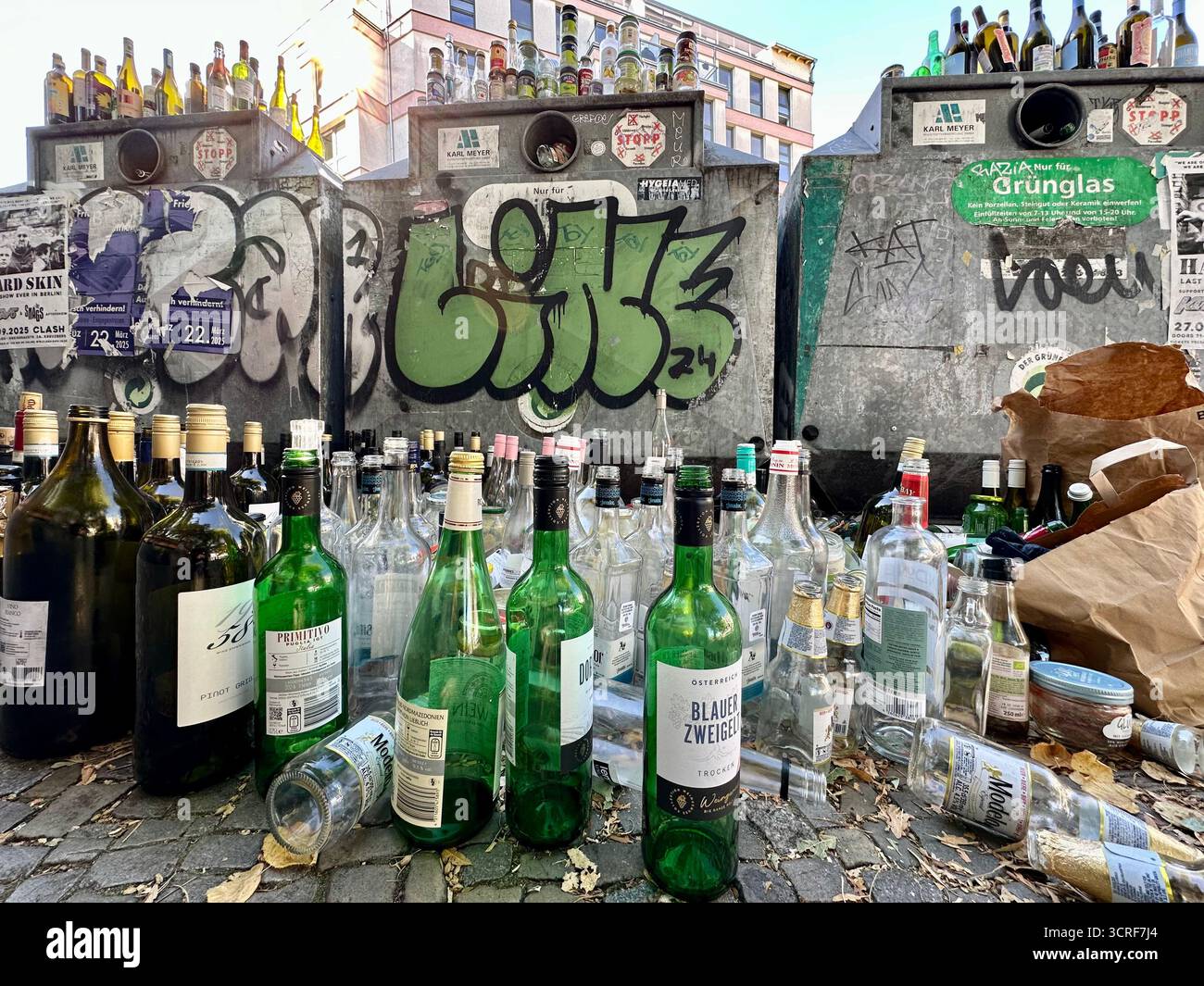 Overflowing glass collection containers in Berlin - Smartphone Captured Stock Image