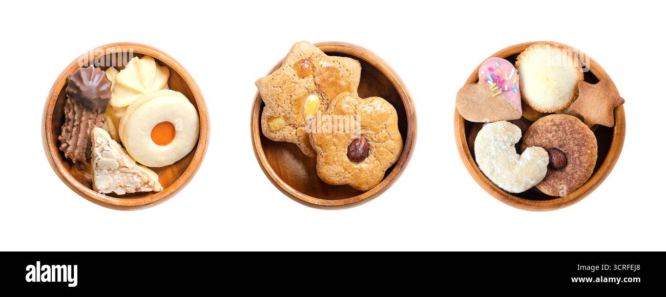 Variety of Christmas cookies and biscuits in wooden bowls. Traditional gingerbread and butter cookies, in different shapes. Stock Photo