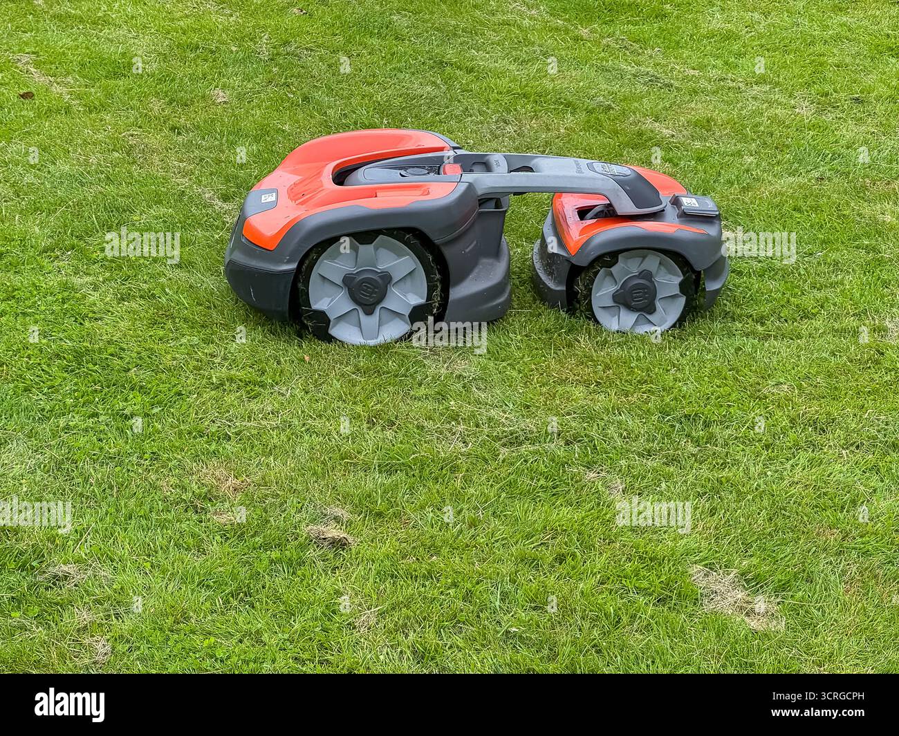 Automated lawn mower - Jonsereds Gardens, Jonsereds trädgårdar, Gothenburg, Sweden - Smartphone Captured Stock Image