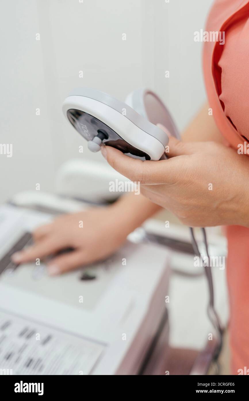 Device, treatment, clinic. Hand operating medical machine, pressing ...