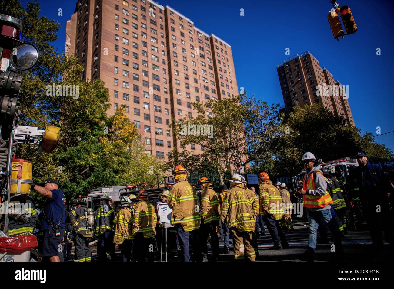 Firefighters work near the site of a building collapse in the Bronx ...