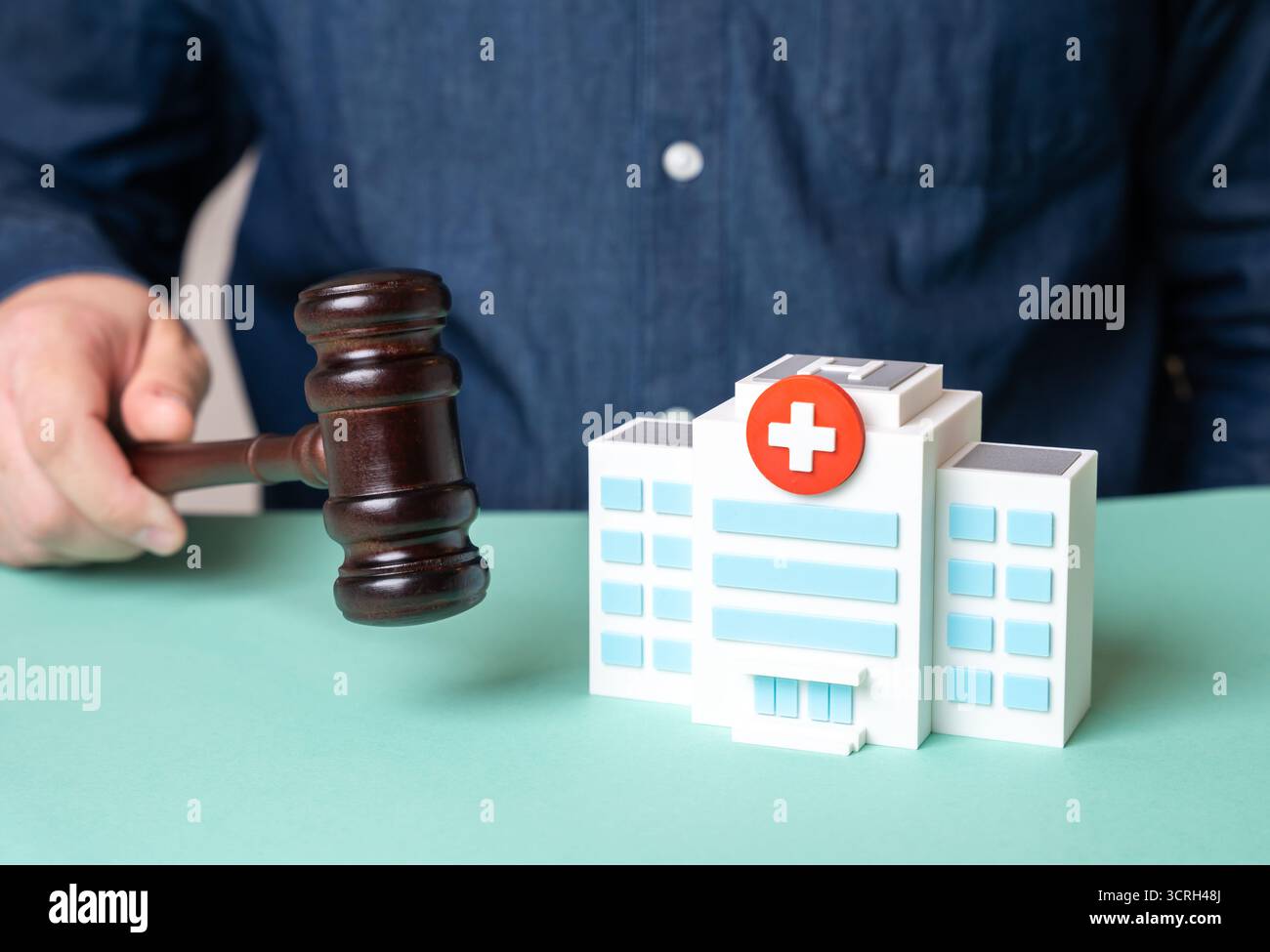 A lawsuit and a hospital. A medical dispute resolution court. Health insurance. Medical malpractice. Useful for law, healthcare policy, patient rights Stock Photo