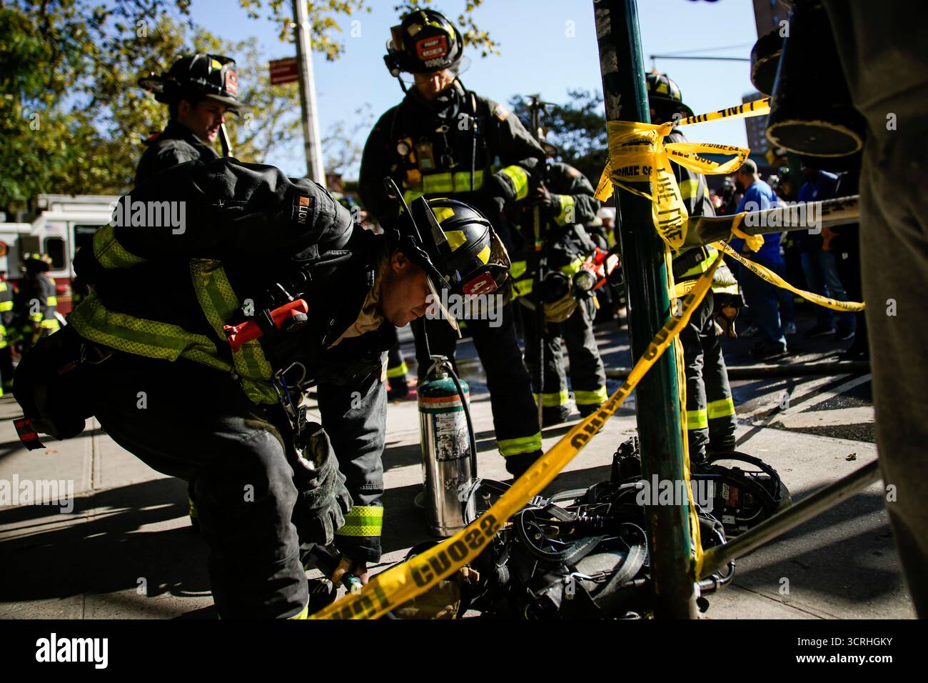 Firefighters work near the site of a building collapse in the Bronx ...