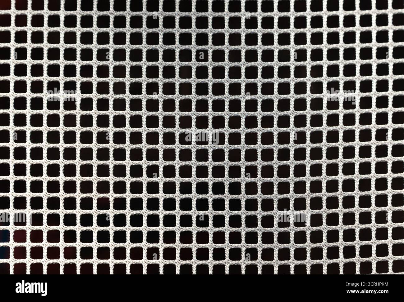 White mesh on black background, cellular grid pattern with geometric texture, close up Stock Photo