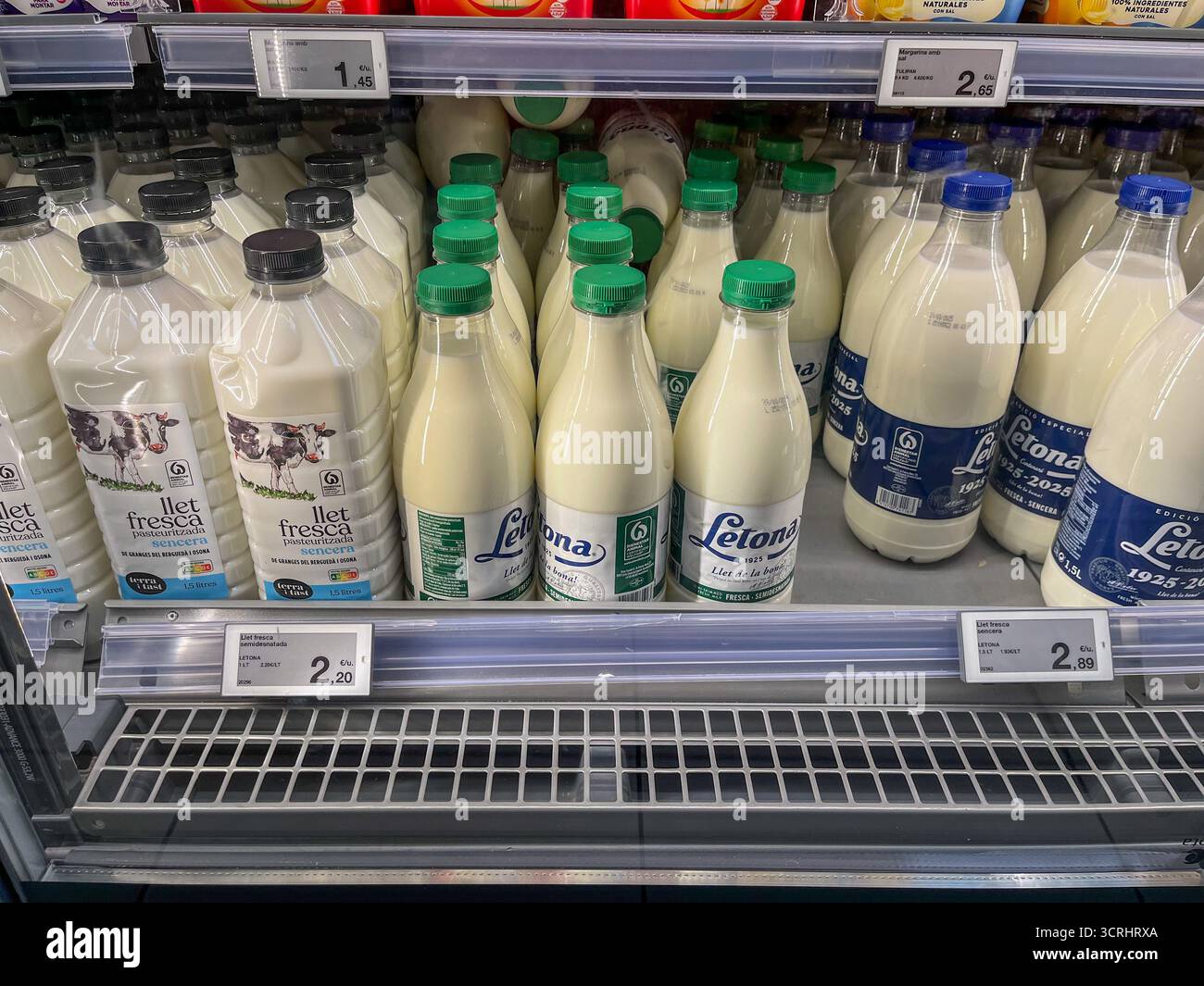 Supermarket Esclat, Spain, Catalonia, Tossa de mar. 14.08.2025. Dairy section with different kind of milk in plastic bottles in a supermarket. - Smartphone Captured Stock Image