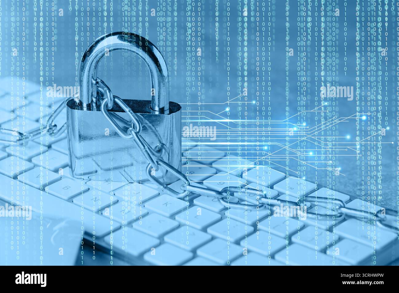 Padlock and chain on computer keyboard, toned in blue. Circuit board pattern and binary code. Cyber security Stock Photo