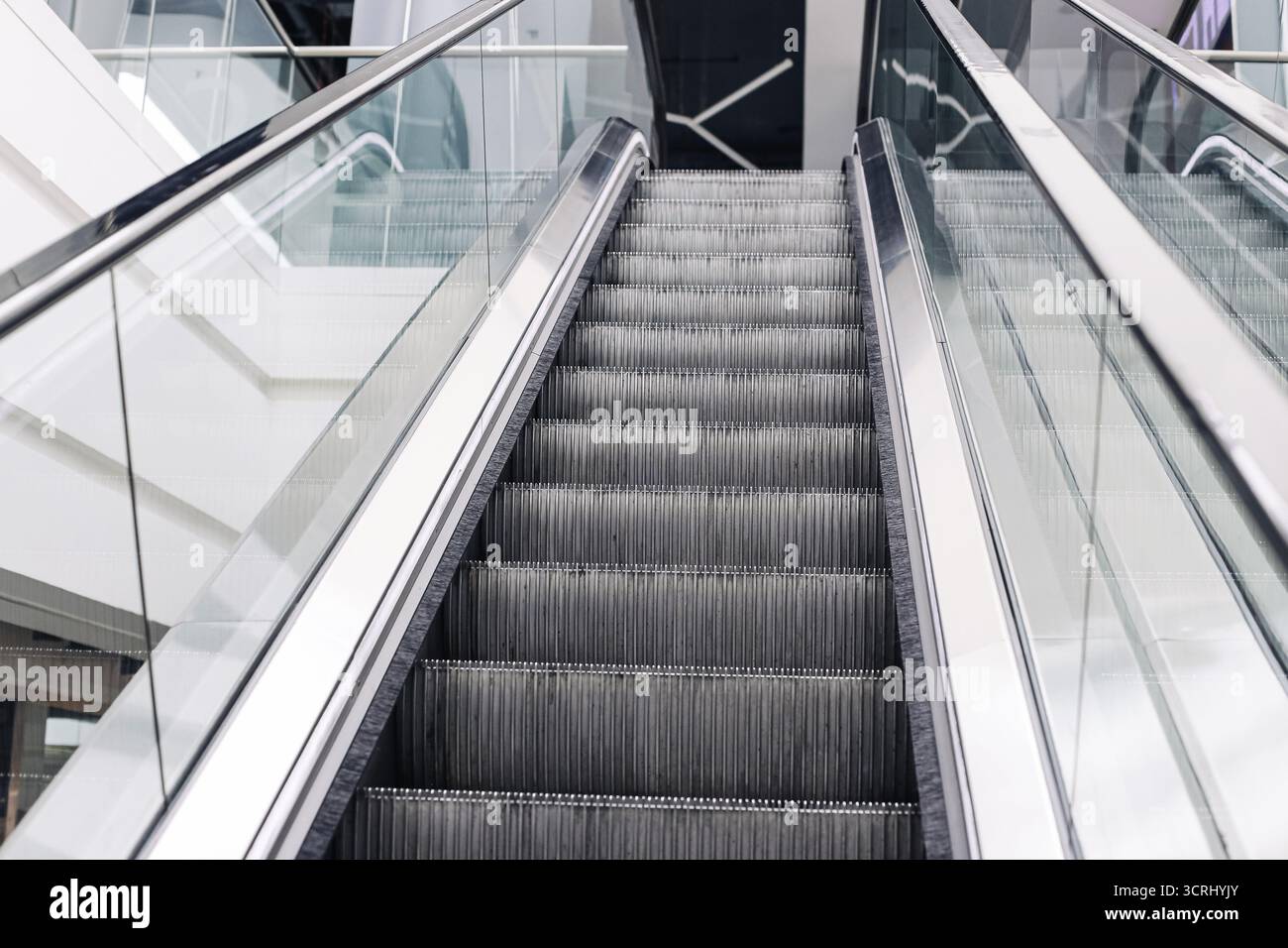 Modern escalator interior. Empty moving stairs in shopping mall. Transportation design background. Moving staircase detail closeup. Urban architecture Stock Photo