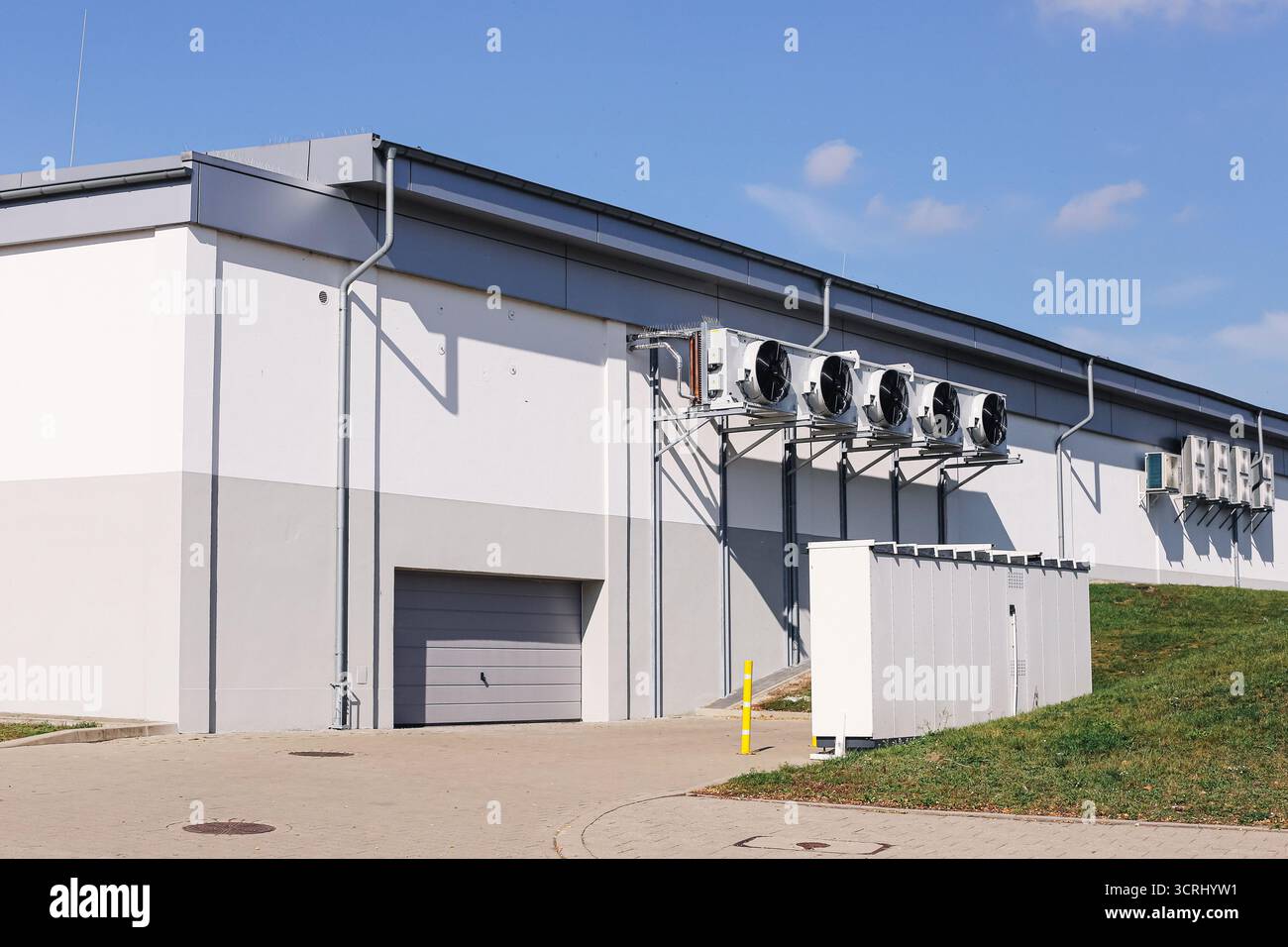Industrial building exterior with ventilation system. Large warehouse with modern cooling units. Architecture of production facility outside. Stock Photo
