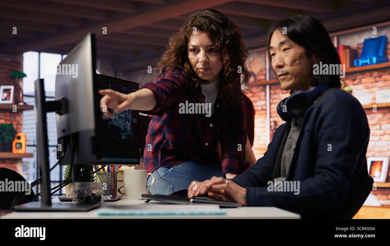 Coworkers collaborating in AI tech agency providing software development services. Teamworking startup office colleagues using artificial intelligence to streamline coding process, camera B Stock Photo
